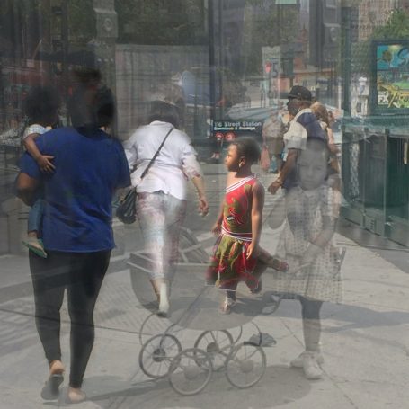 Dairy’s Choice, Shea Butter, Burger King and Things People walk in an urban area, with reflections creating a layered effect, with a little girl in a red dressed centered.