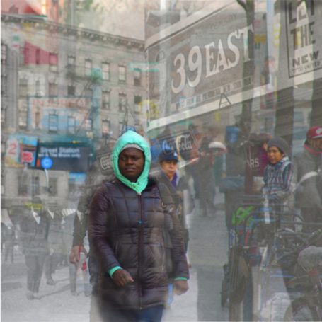 From East To West A bustling city street scene with blurred figures and vibrant storefronts.